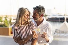 Mature couple toasting drinks, sharing a moment of romance and enjoying vacation