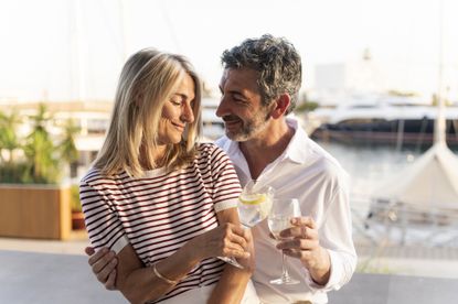 Mature couple toasting drinks, sharing a moment of romance and enjoying vacation