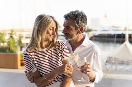 Mature couple toasting drinks, sharing a moment of romance and enjoying vacation
