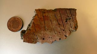 This fragment of pottery may have been part of a Bronze Age burial urn.