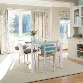 kitchen room with white door and white table with chairs