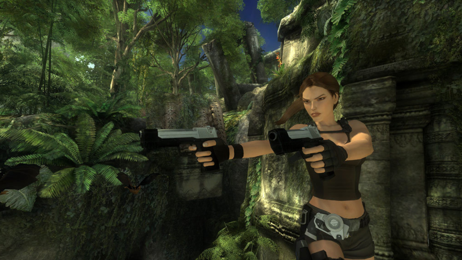 Lara Croft holding two guns and pointing them straight ahead of her while standing in a jungle during one of the best Tomb Raider games, Tomb Raider: Underworld.