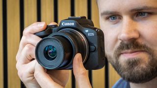 The Canon EOS R100 being held by photographer Dan Mold