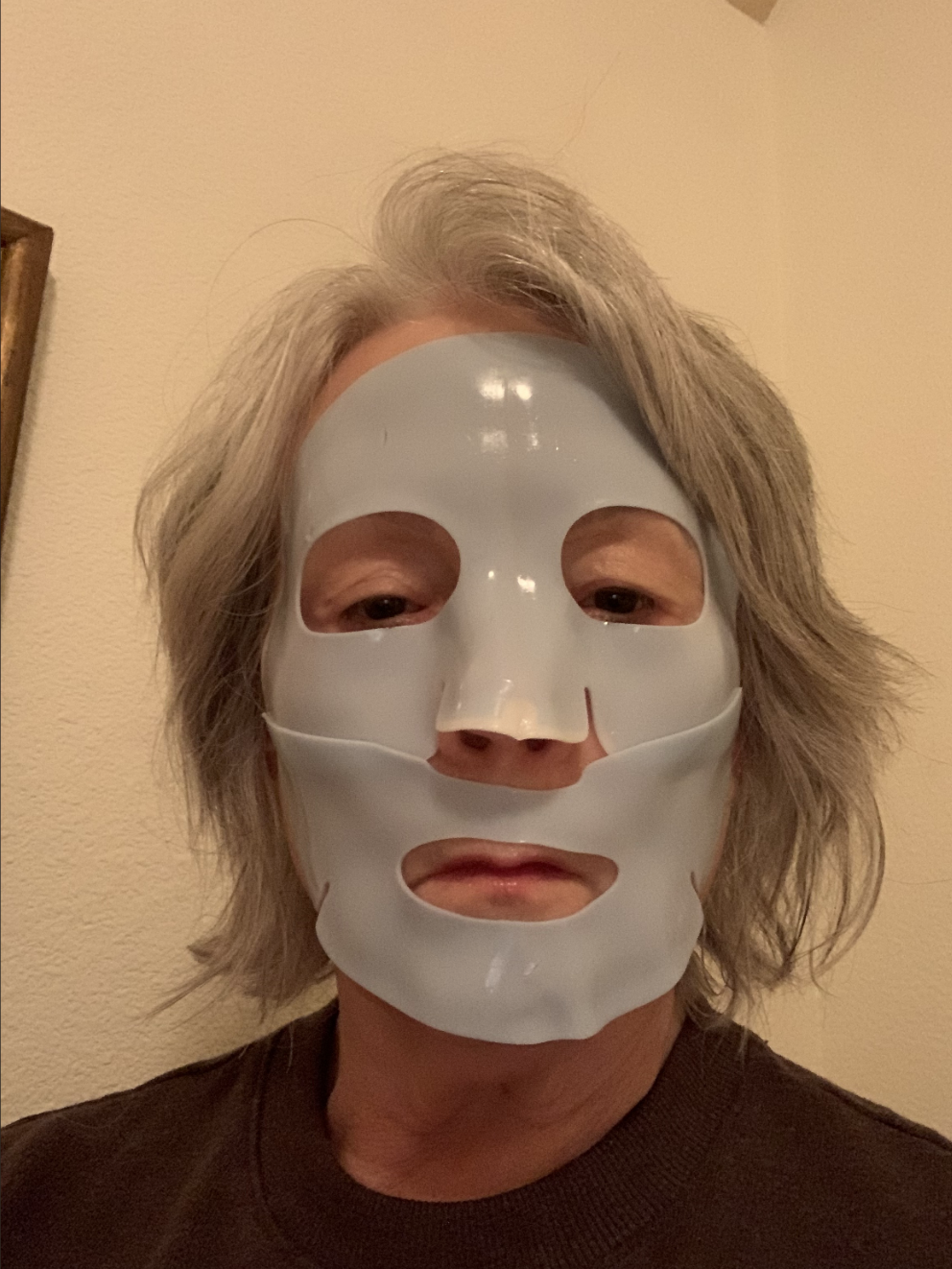 woman with gray hair and a blue mask on