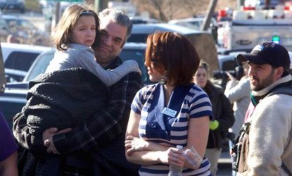 Parents pick up their children outside Sandy Hook Elementary after a deadly school shooting in Newtown, Conn.
