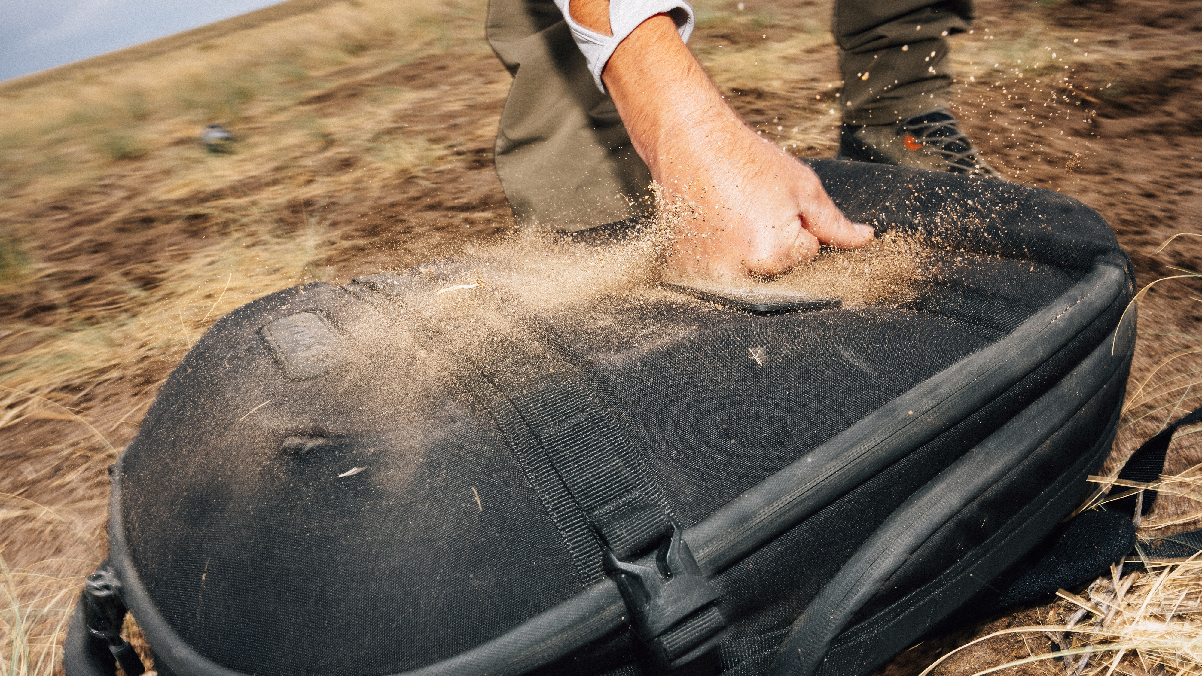 The Pelican Aegis backpack covered in sand