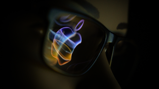 The Apple logo reflected in someone's glasses