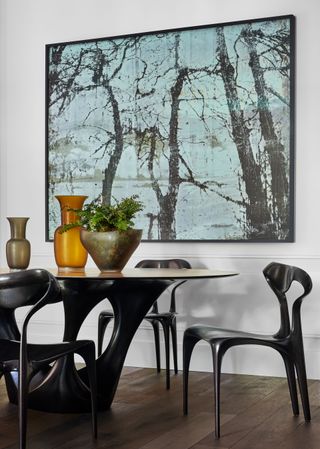 Blur painting with black trees, black chairs and table stand