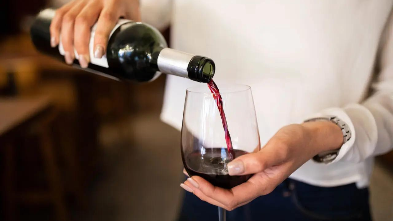 woman pouring glass of red wine