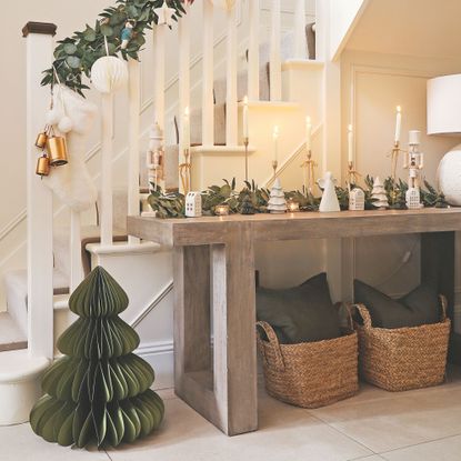 Neutral hallway decorated with green christmas decorations