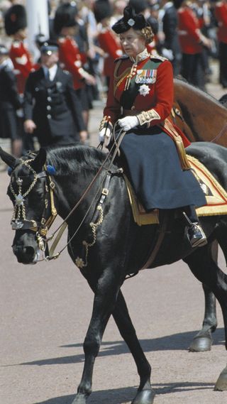 Queen Elizabeth II, wearing ceremonial dress, riding sidesaddle during the Trooping the Colour ceremony