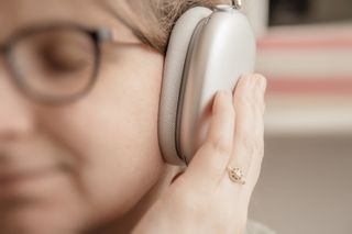 Woman listens to new best Apple Computers AirPods Max over-ear headphones enjoying the pure clear sound