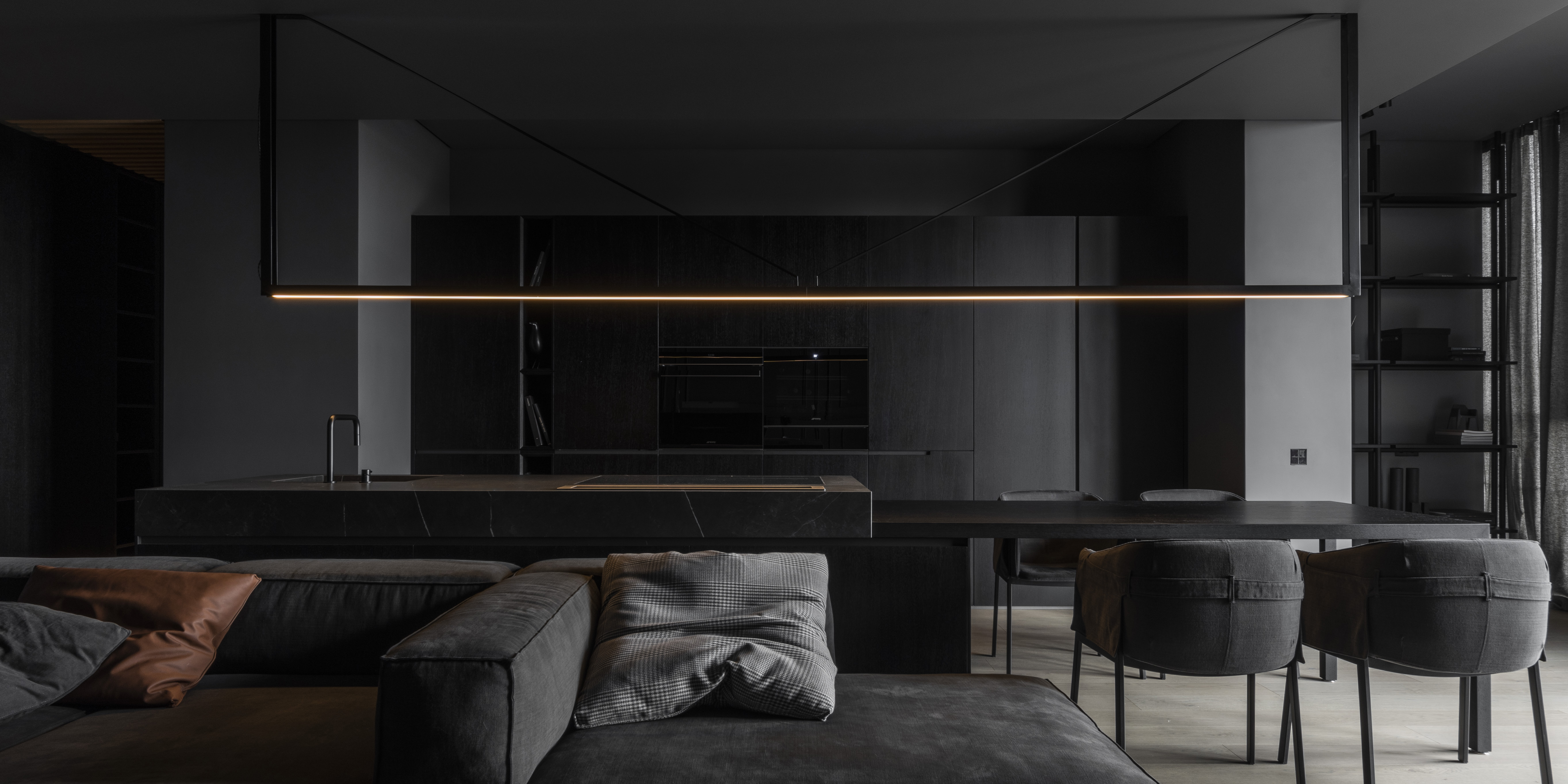Dark interiors with chairs and sofas