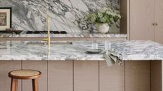 a modern marble and wood kitchen with a decoratively edged countertop profile