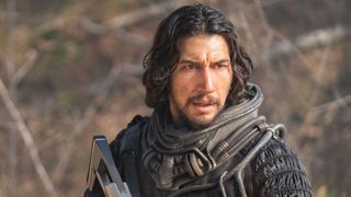 Adam Driver as Mills, seen from the upper chest up wearing futuristic armor, in 65
