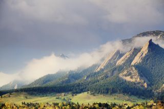 First light on the Boulder Colorado Flatirons as a storm clears