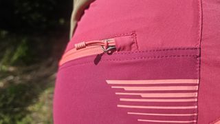 Close up of side of pink shorts showing the rear pocket zip