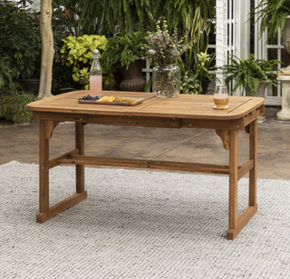 Brown wood extendable outdoor dining table.