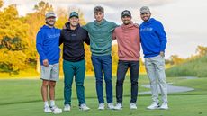 Five men wearing Good Good Golf apparel standing arm in arm on a golf course