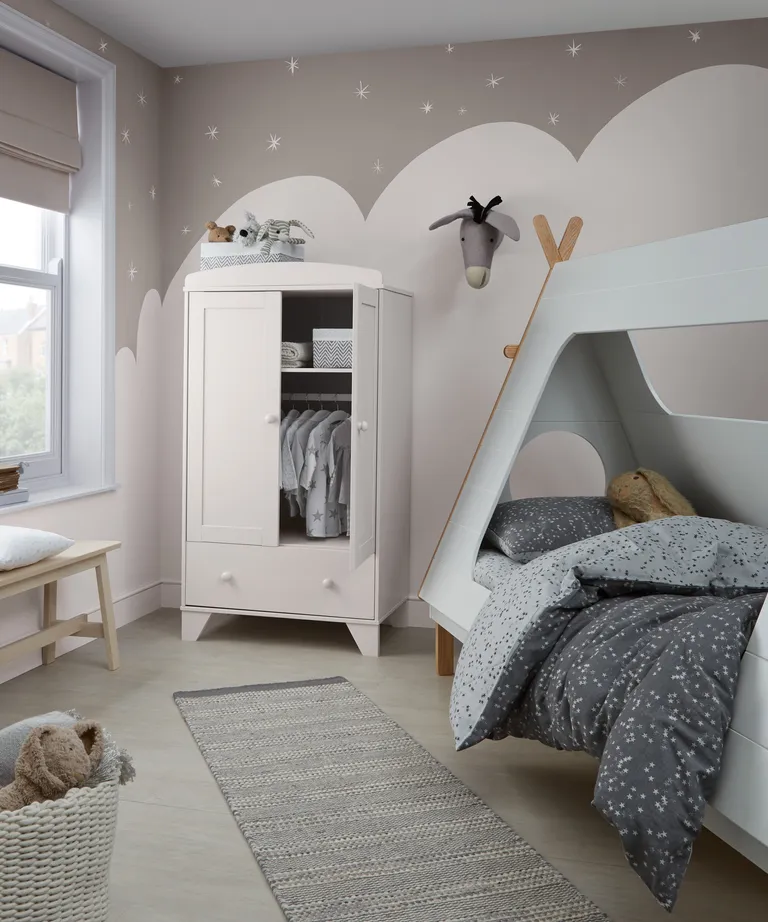 A child's bedroom with wall mural depicting a snowy landscape