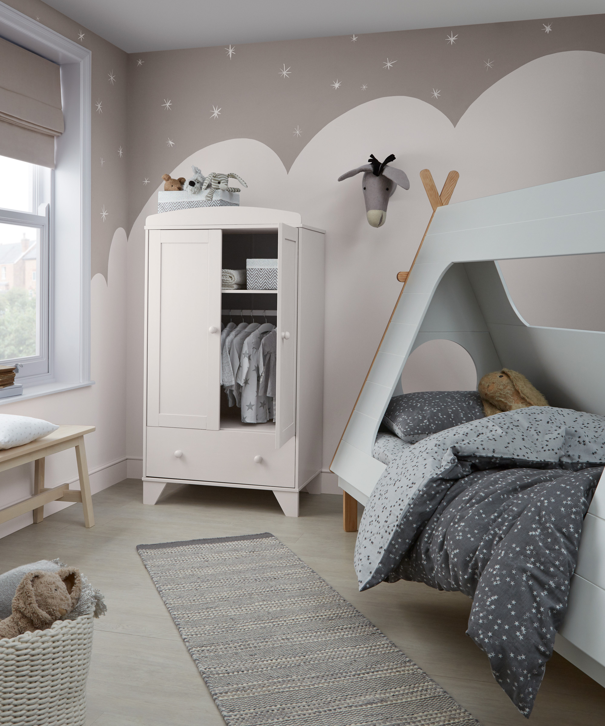 A child's bedroom with wall mural depicting a snowy landscape, illustrating imaginative boys' bedroom ideas.