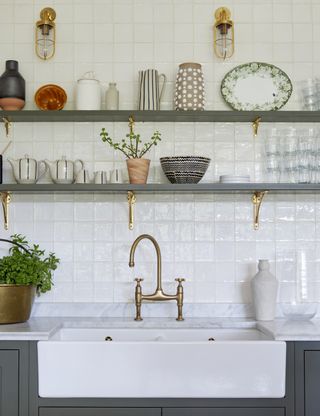 kitchen with white butler sink open shelving and white tiles