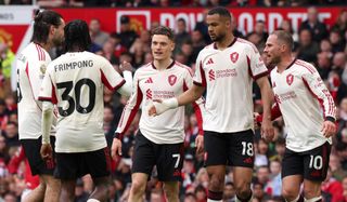 Cody Gakpo of Liverpool celebrates scoring his team's second goal with teammates during the Premier League match between Manchester United and Liverpool at Old Trafford