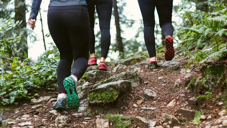 women running on a trail to lose weight from your thighs