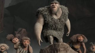 The members of the Croods family looking at a discovery in The Croods