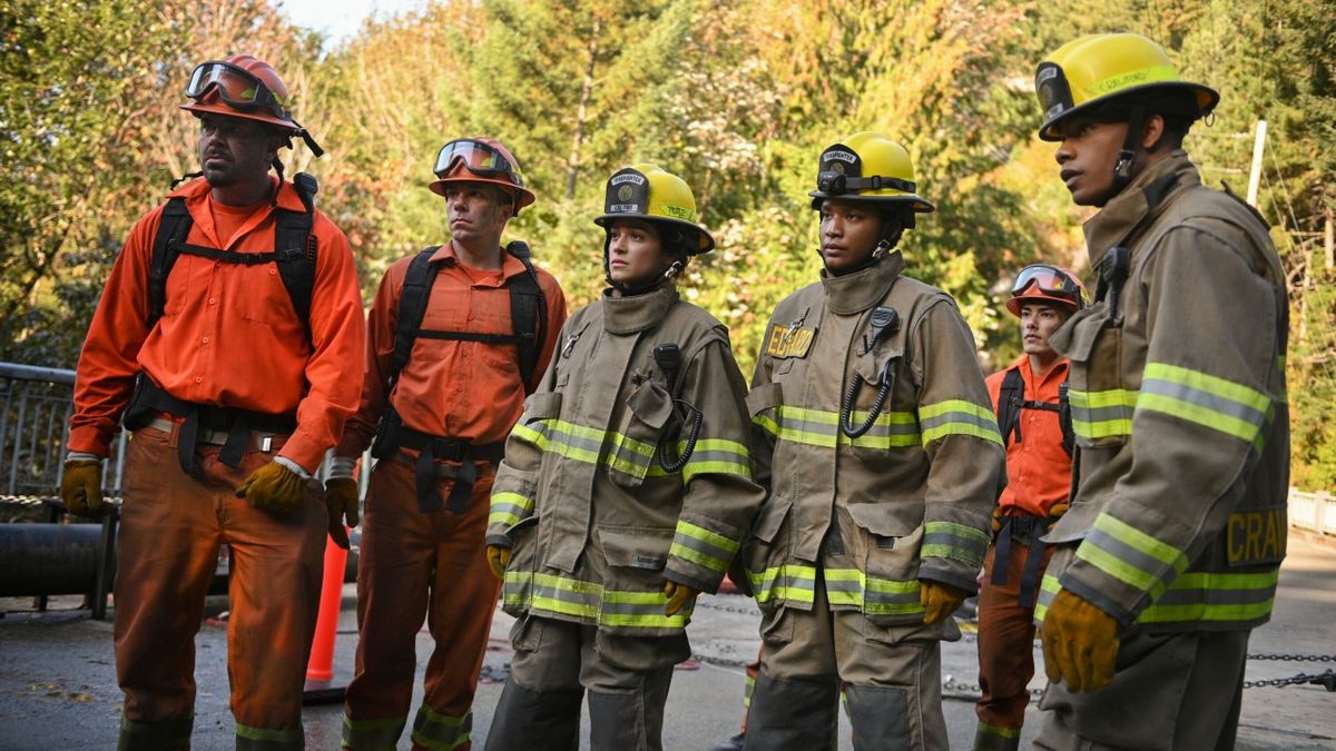 From left to right: two 3 Rock fire fighters, Gabrielle, Eve and Jake standing on a bridge