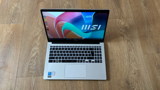 MSI Modern 15 laptop on a wooden desk