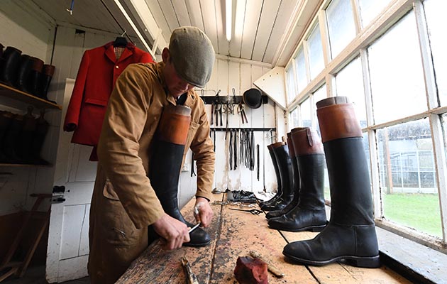 Top turnout: Harry gets to work on his boots