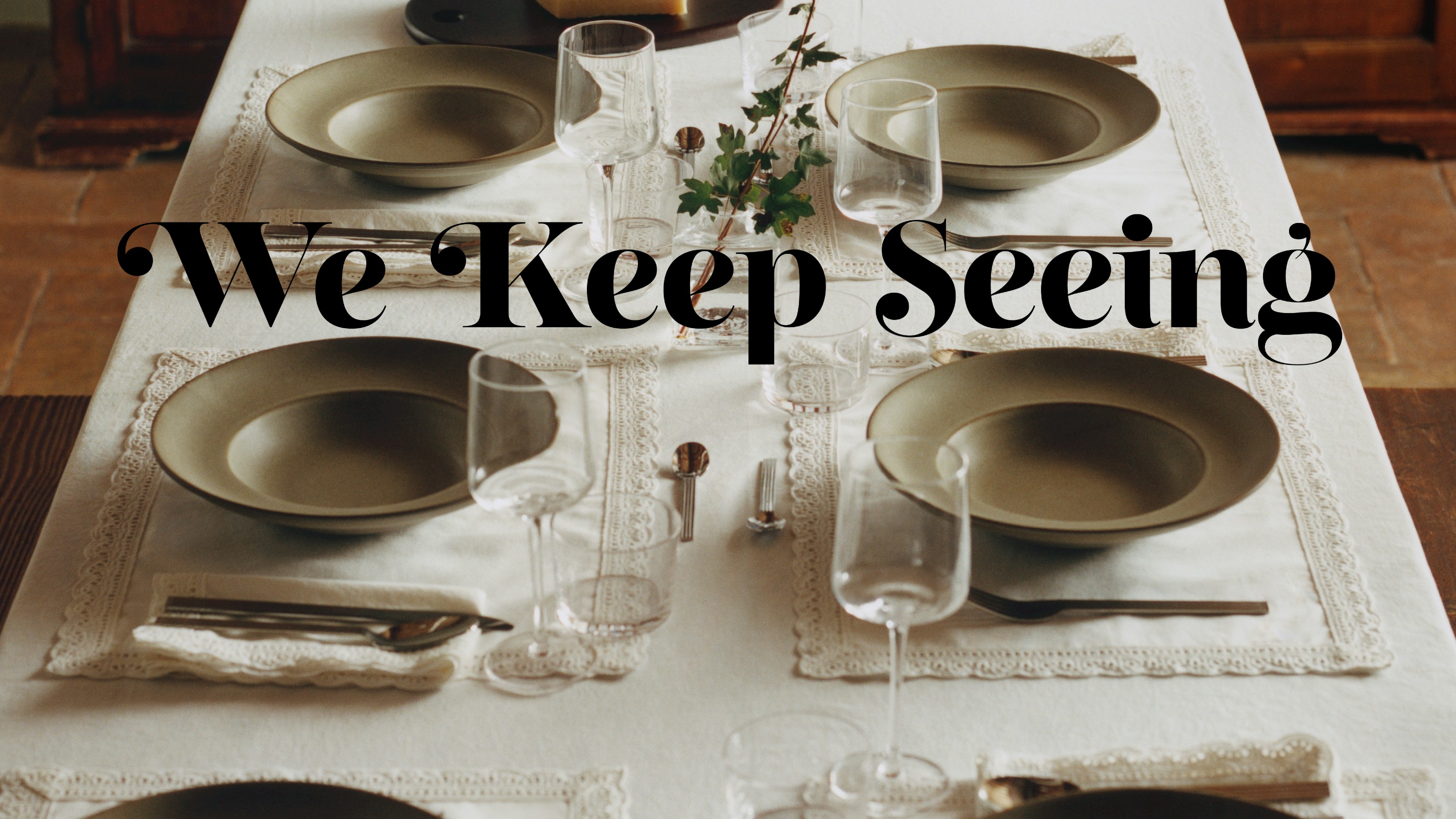 A set dining table with a white tablecloth and white lace-trimmed placemats and napkins from H&amp;M Home's spring/summer 2026 collection 