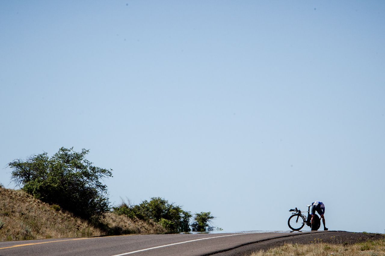 A rider stops to fix a dropped chain.