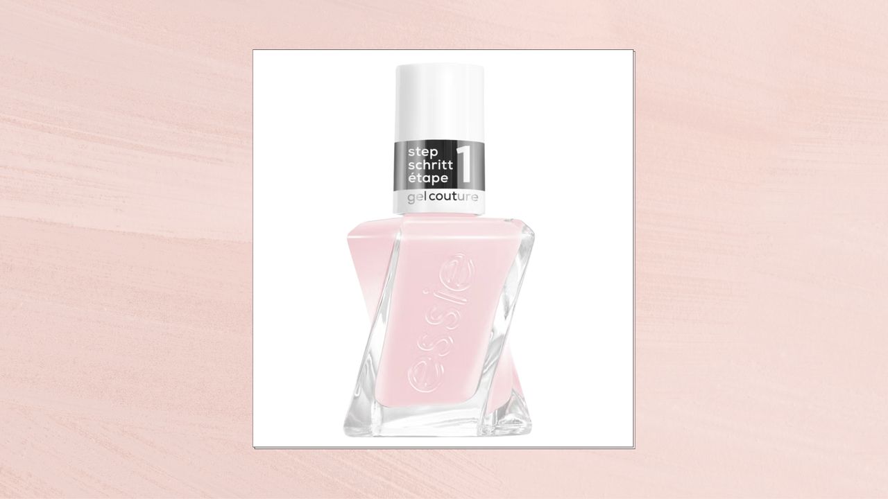 A product shot of essie&#039;s Matter Of Fiction nail polish, which is a sheer, milky pink shade and is pictured on a white background/ and in a pink template