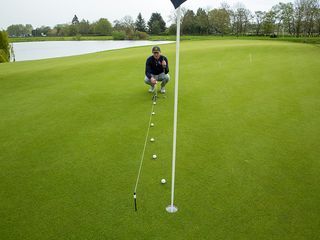 Golf Monthly Top 50 Coach John Howells demonstrating break on a putting green