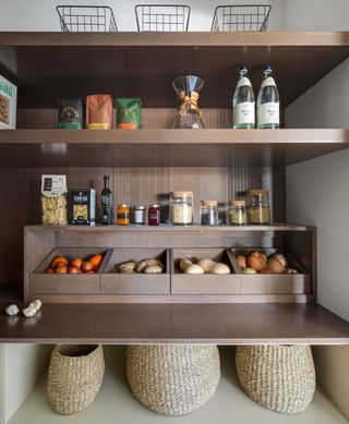 kitchen pantry storage with custom solutions, shelving, boxes for vegetables, spices on top, baskets underneath