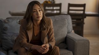 Renee Ballard sitting on a couch in her self-titled Bosch spin-off series on Prime Videp