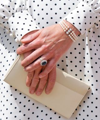 Pair of hands wearing fine jewellery