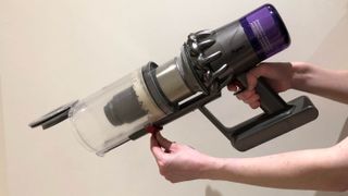 The Dyson V11 vacuum cleaner canister being opened