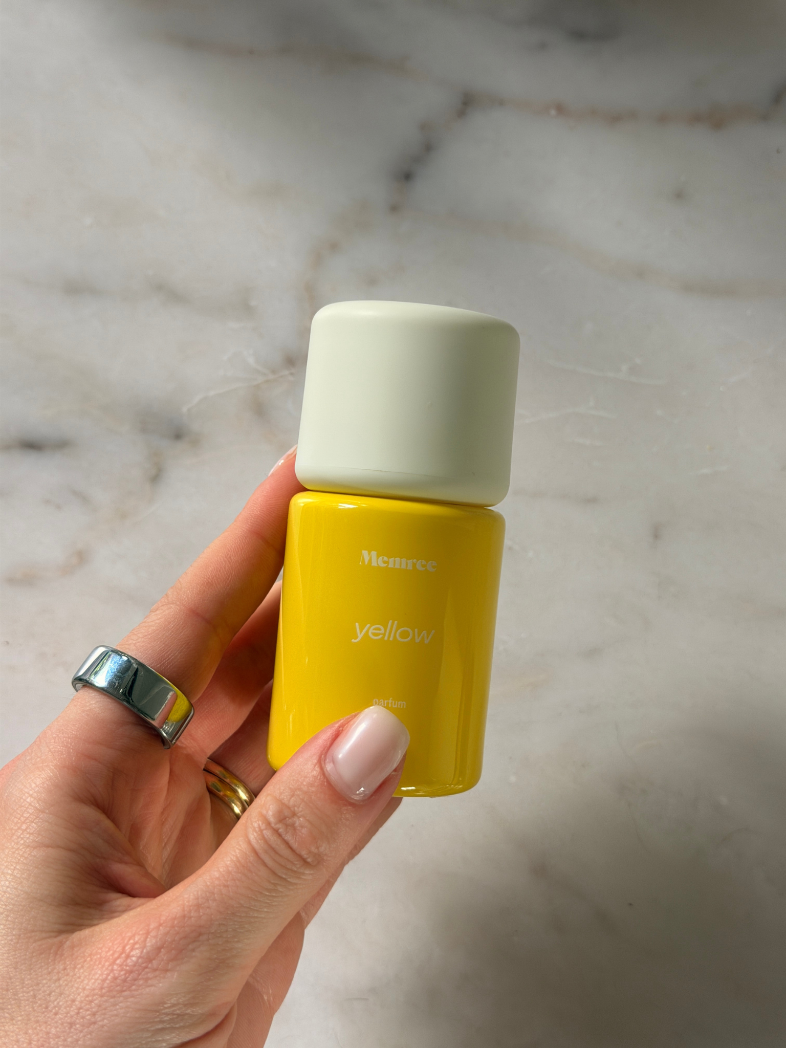 Grace holding a bottle of Memree perfume