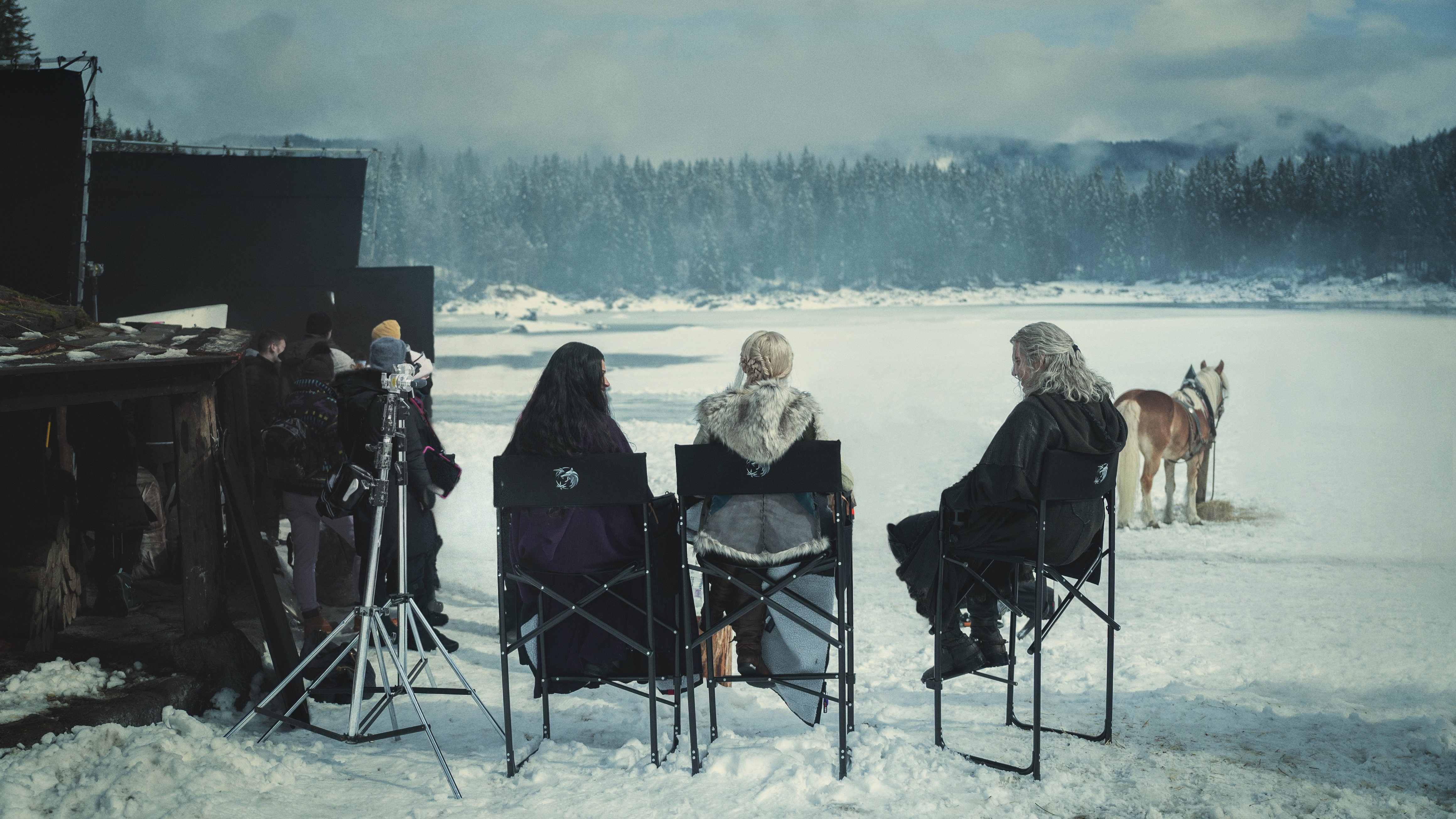 The Witcher's main cast sit together in a snowy location as filming on season 3 gets underway