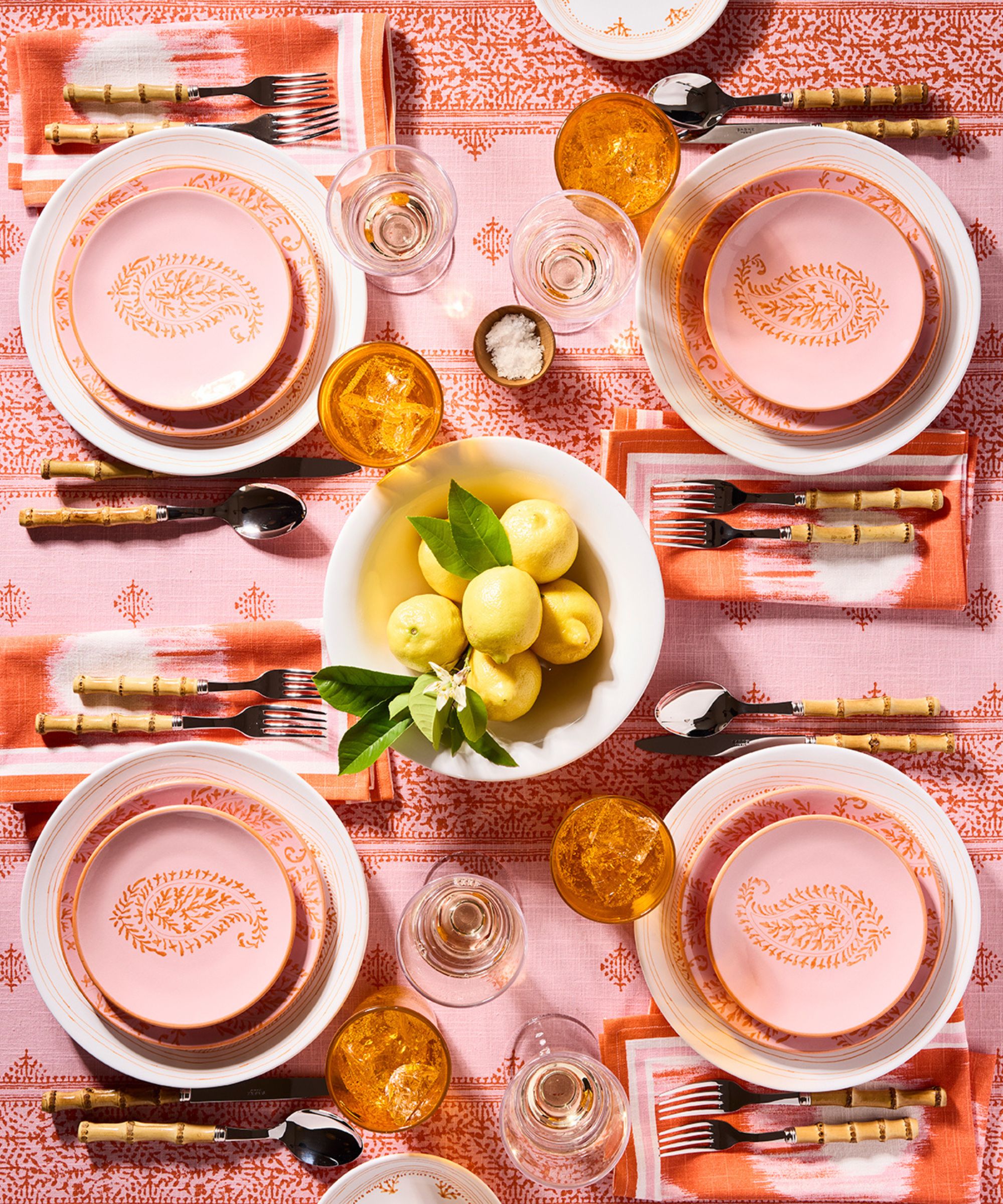 Pink table setting with bowl of lemons in the center