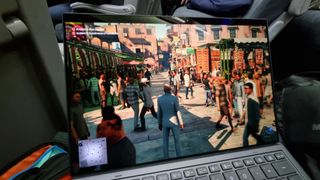 An Intel Core Ultra Series 3 laptop being used to play Hitman on a UK train