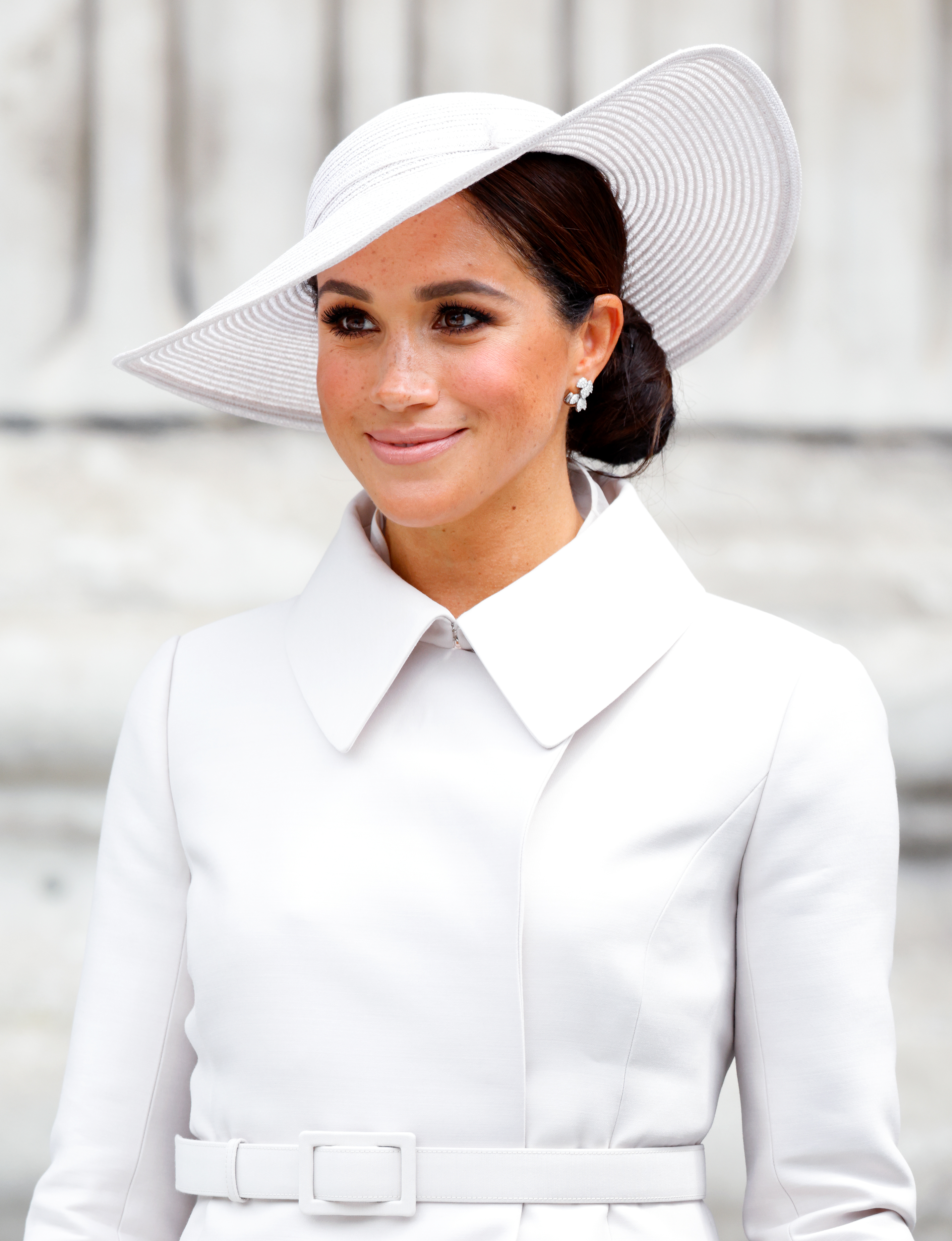 Meghan Markle wearing a white coat and hat at St Paul's Cathedral in 2022
