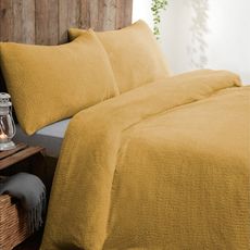 bedroom with ochre bedding