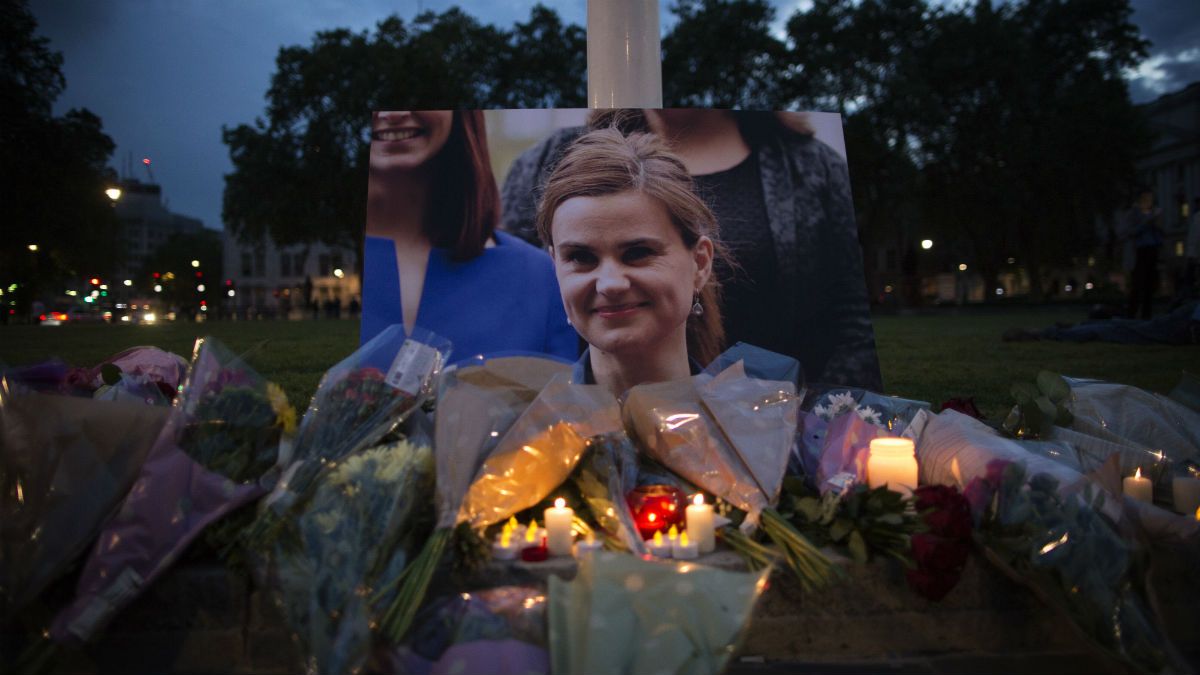 Flowers surround a picture of pro-EU politician Jo Cox during a vigil in Parliament Square