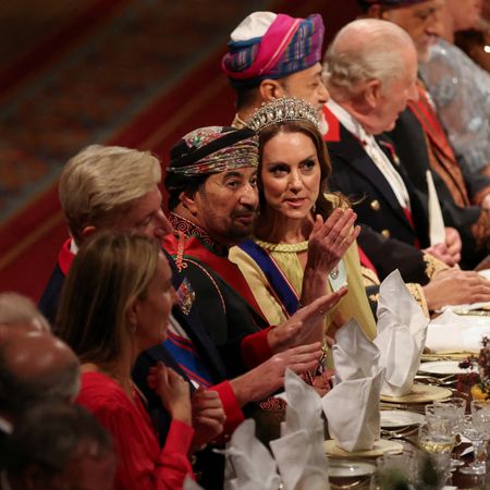 Princess Kate wearing a tiara sitting at a banquet table