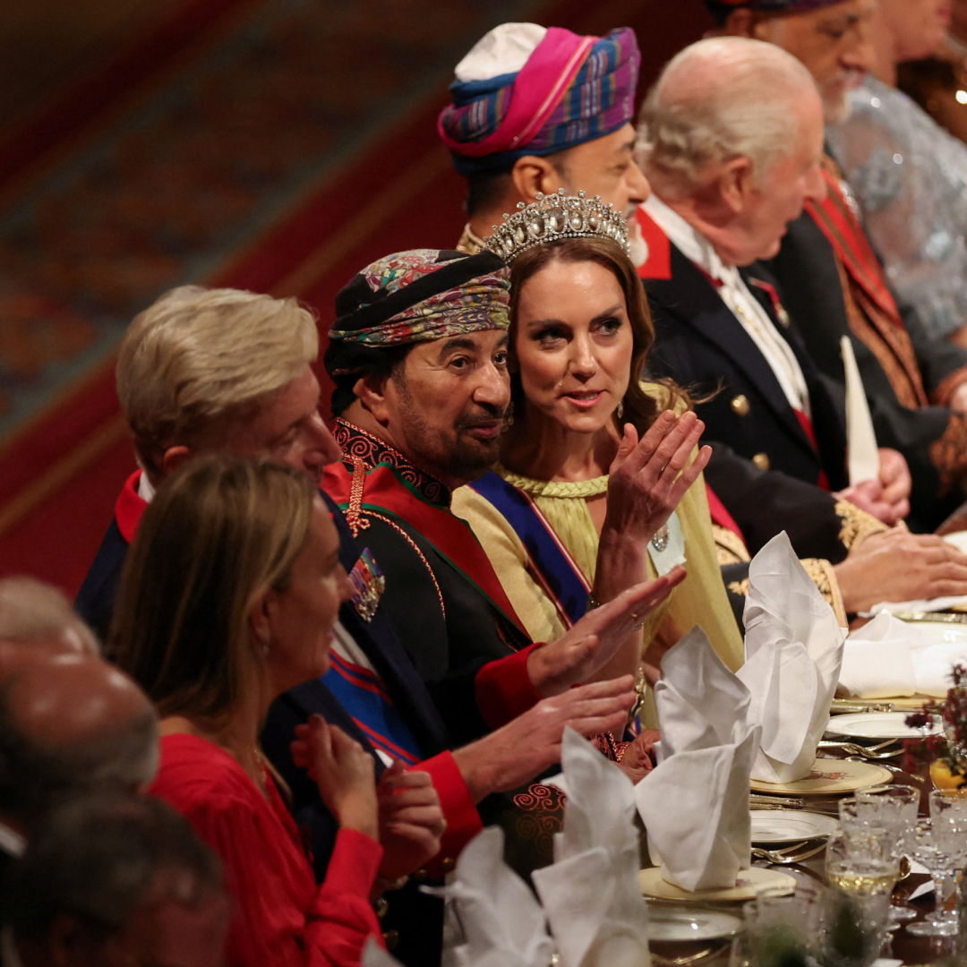 Princess Kate wearing a tiara sitting at a banquet table
