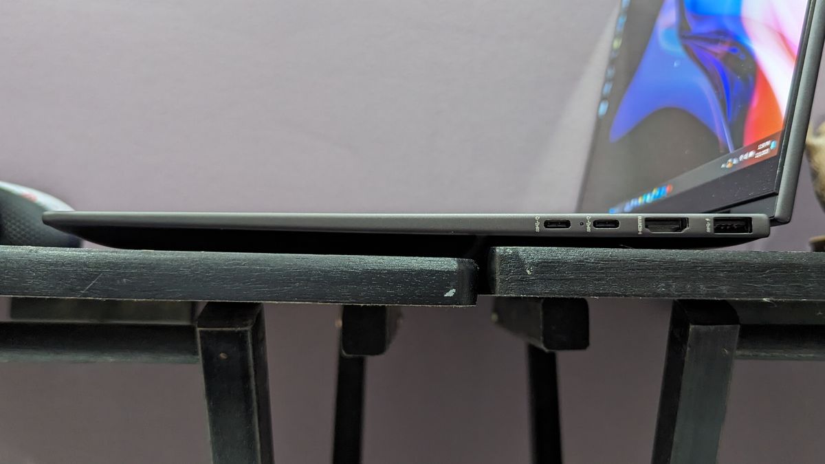 Side-on photo of the HP Envy x360's right-side ports on a black desk.